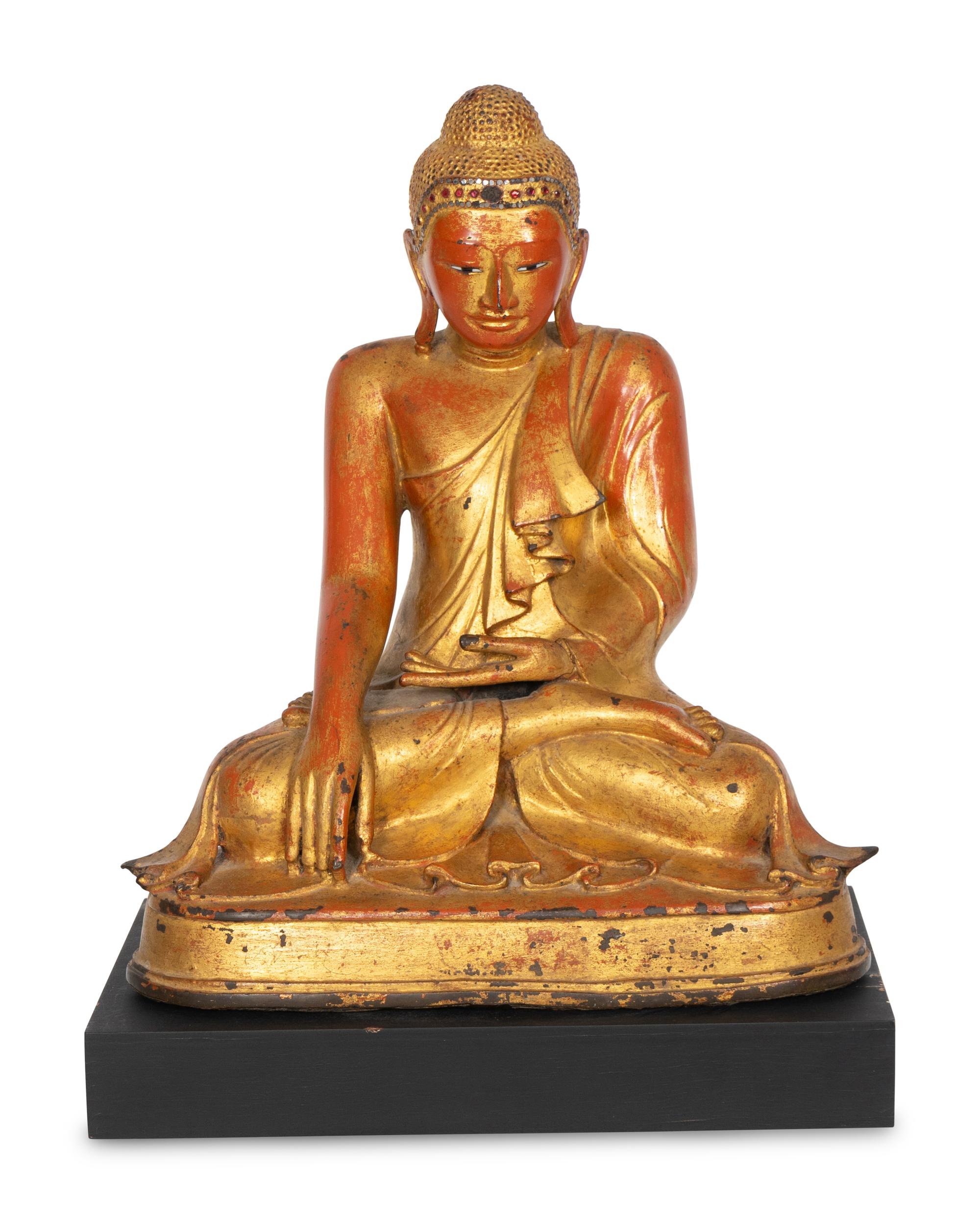 A Burmese Gilt and Red Lacquered Bronze Seated Buddha