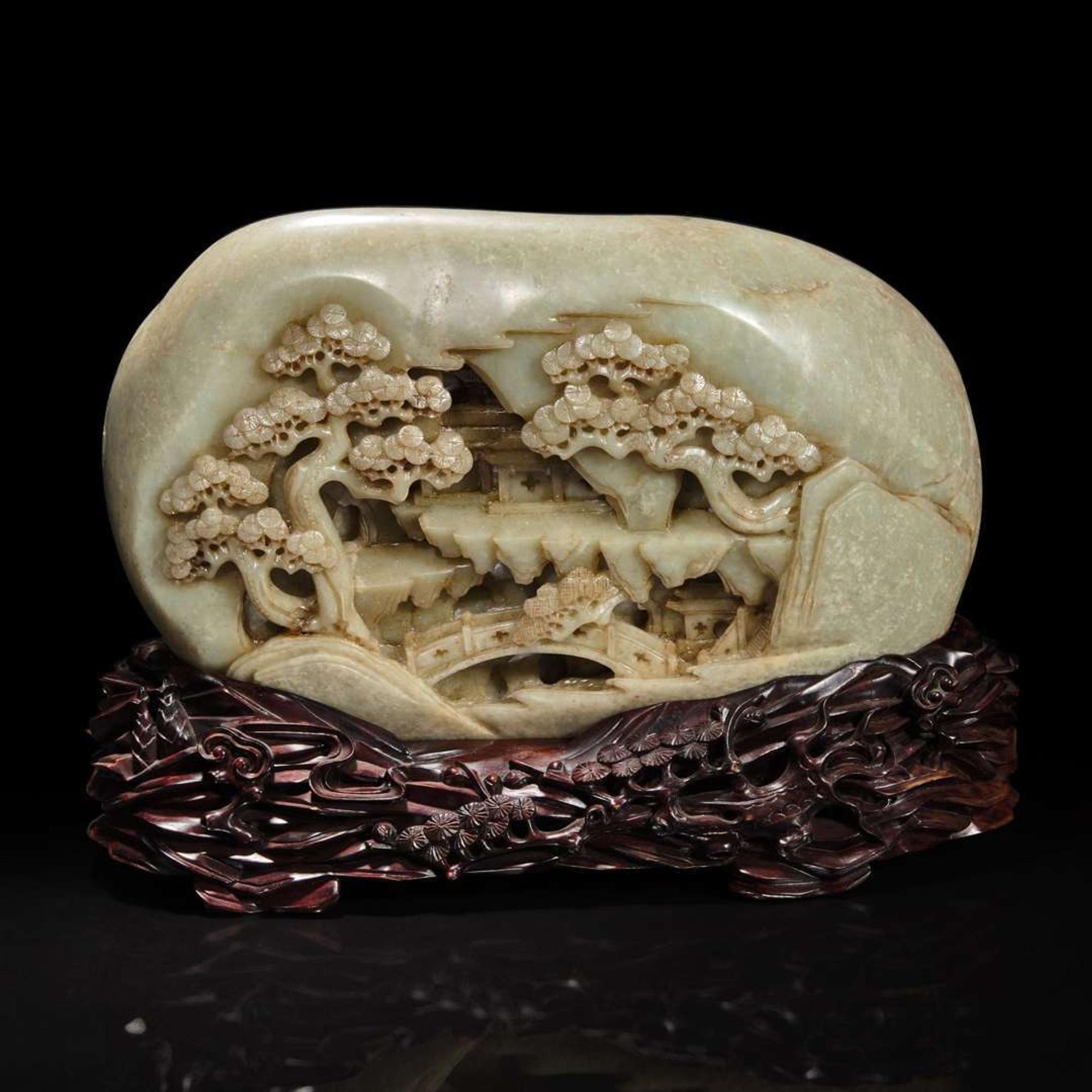 A large Chinese carved greyish celadon jade "Mountain" boulder and carved wood stand 灰青玉山子带底座