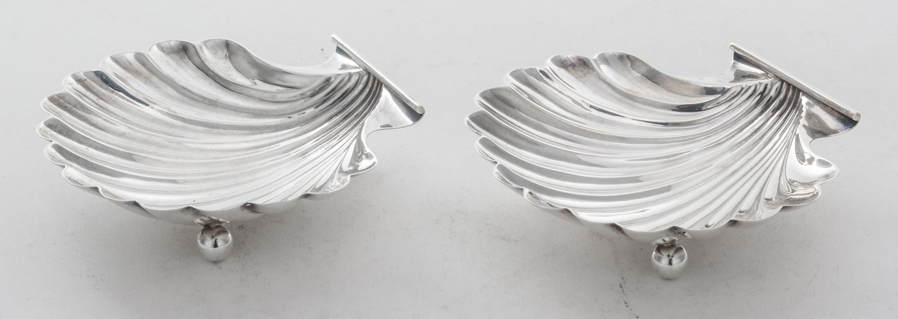 A Pair of American Silver Shell Form Salts, Currier & Roby, New York, NY, raised on three ball feet.