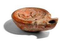 A Roman Terracotta Lamp with Symplegma Scene