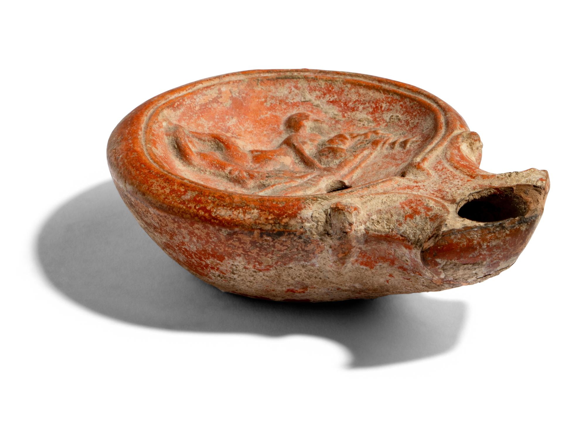 A Roman Terracotta Lamp with Symplegma Scene