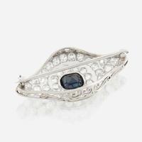 A sapphire, diamond, platinum, and white metal brooch