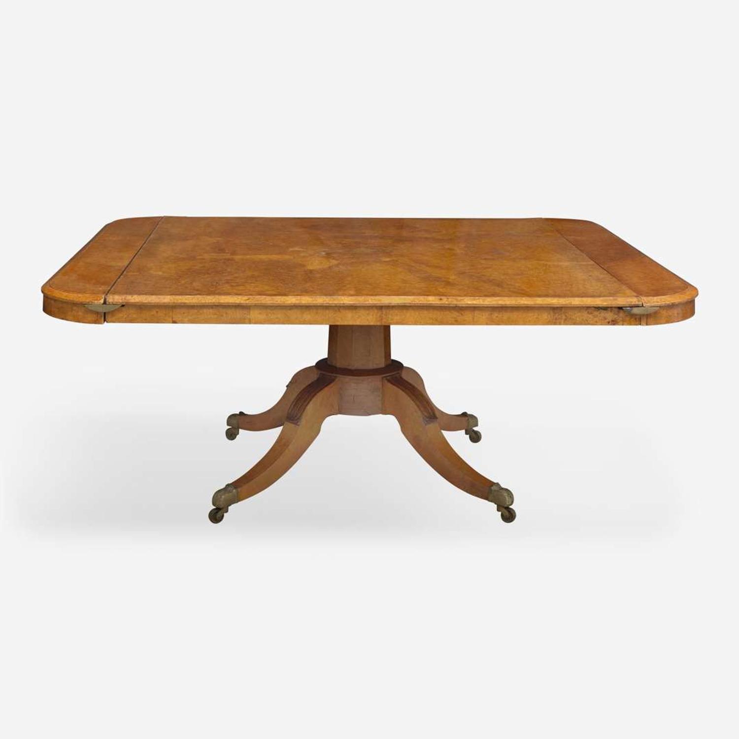 An impressive Regency pollard oak three-pedestal dining table circa 1820