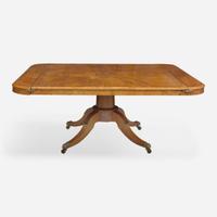An impressive Regency pollard oak three-pedestal dining table circa 1820