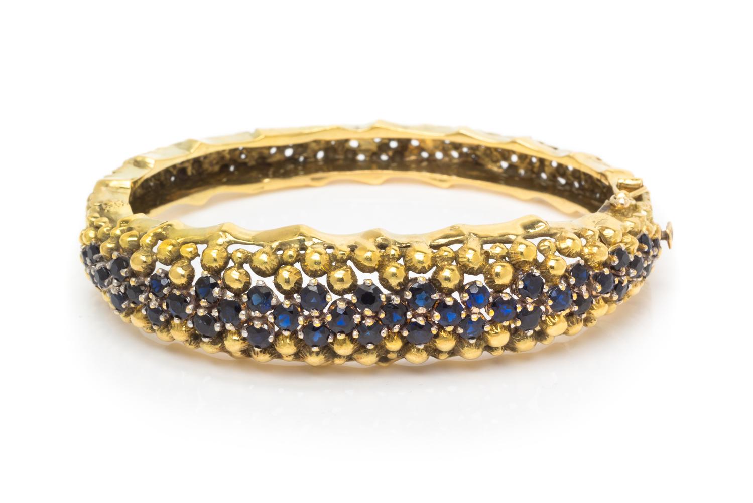 An 18 Karat Yellow Gold and Sapphire Bangle Bracelet, Jack Gutschneider Co., 35.70 dwts.