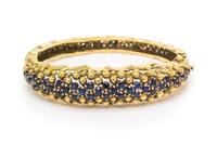 An 18 Karat Yellow Gold and Sapphire Bangle Bracelet, Jack Gutschneider Co., 35.70 dwts.