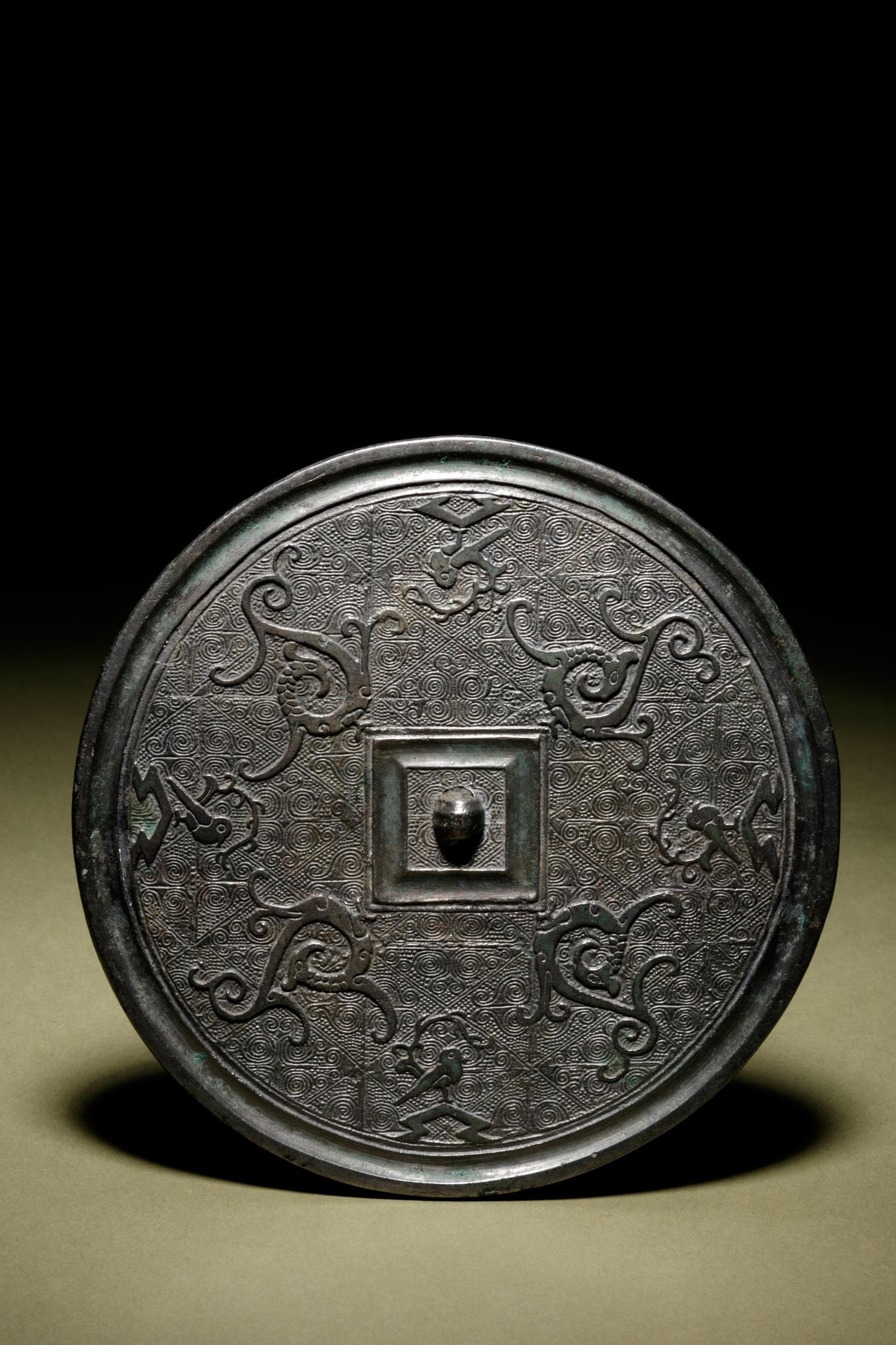 A Bronze Circular 'Phoenix’ Mirror