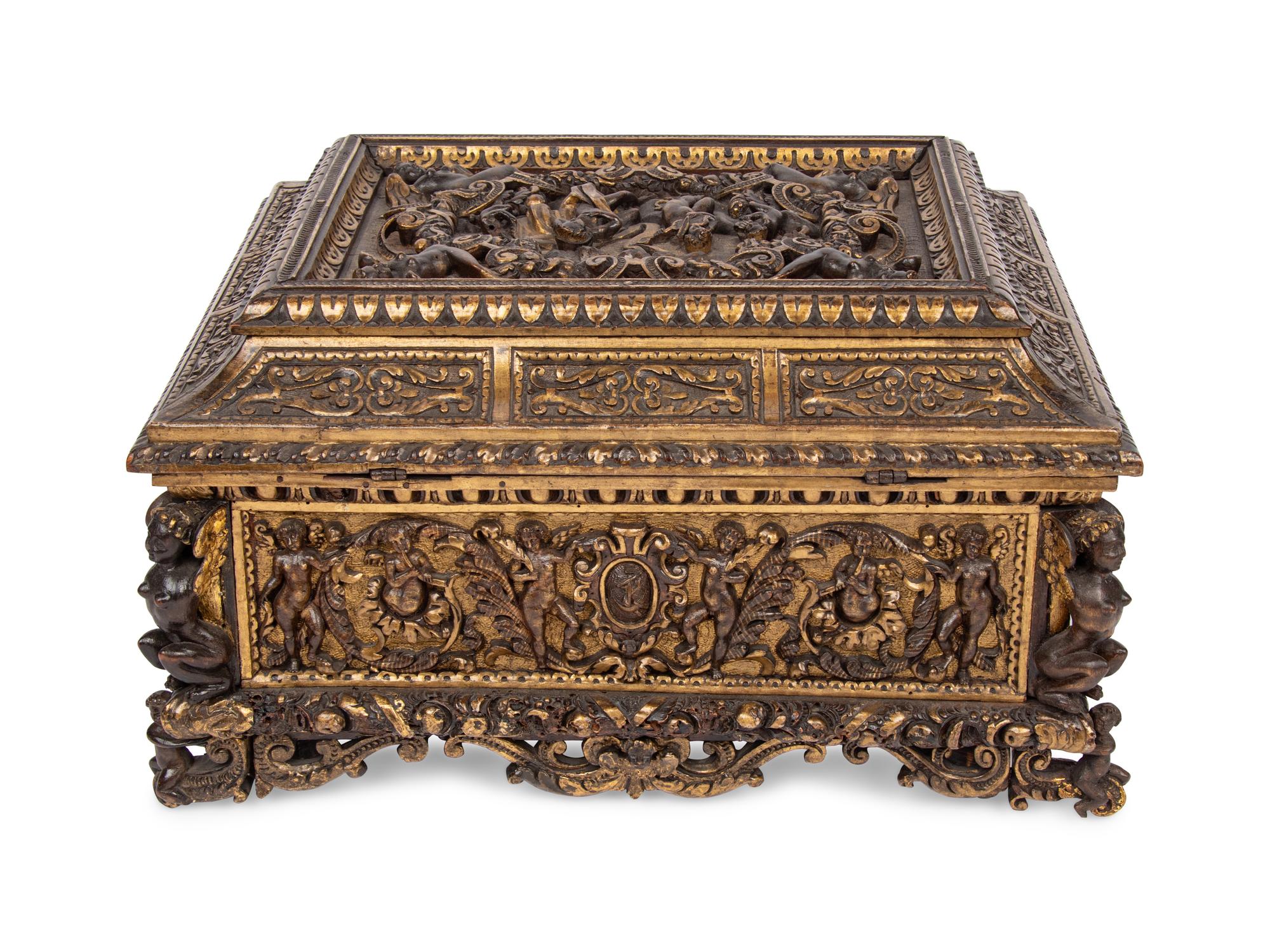 An Italian Parcel Gilt and Carved Walnut Orpheus and Eurydice Casket
