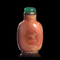 A Chinese Carved Coral-Red "Thumbprint" Agate Snuff Bottle