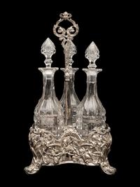 An English Silver-Plate Tantalus with Three Cut Glass Decanters