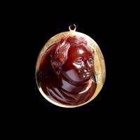A Roman Carnelian Cameo of a Boy — Set in a gold pendant