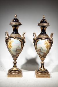 A Pair of Monumental Sèvres Style Gilt Metal Mounted Porcelain Covered Urns on Pedestals