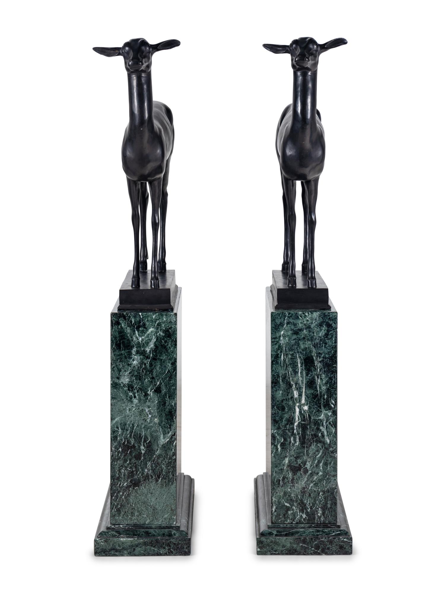 A Pair of Bronze Models of Pompeiian Deer on Marble Plinths