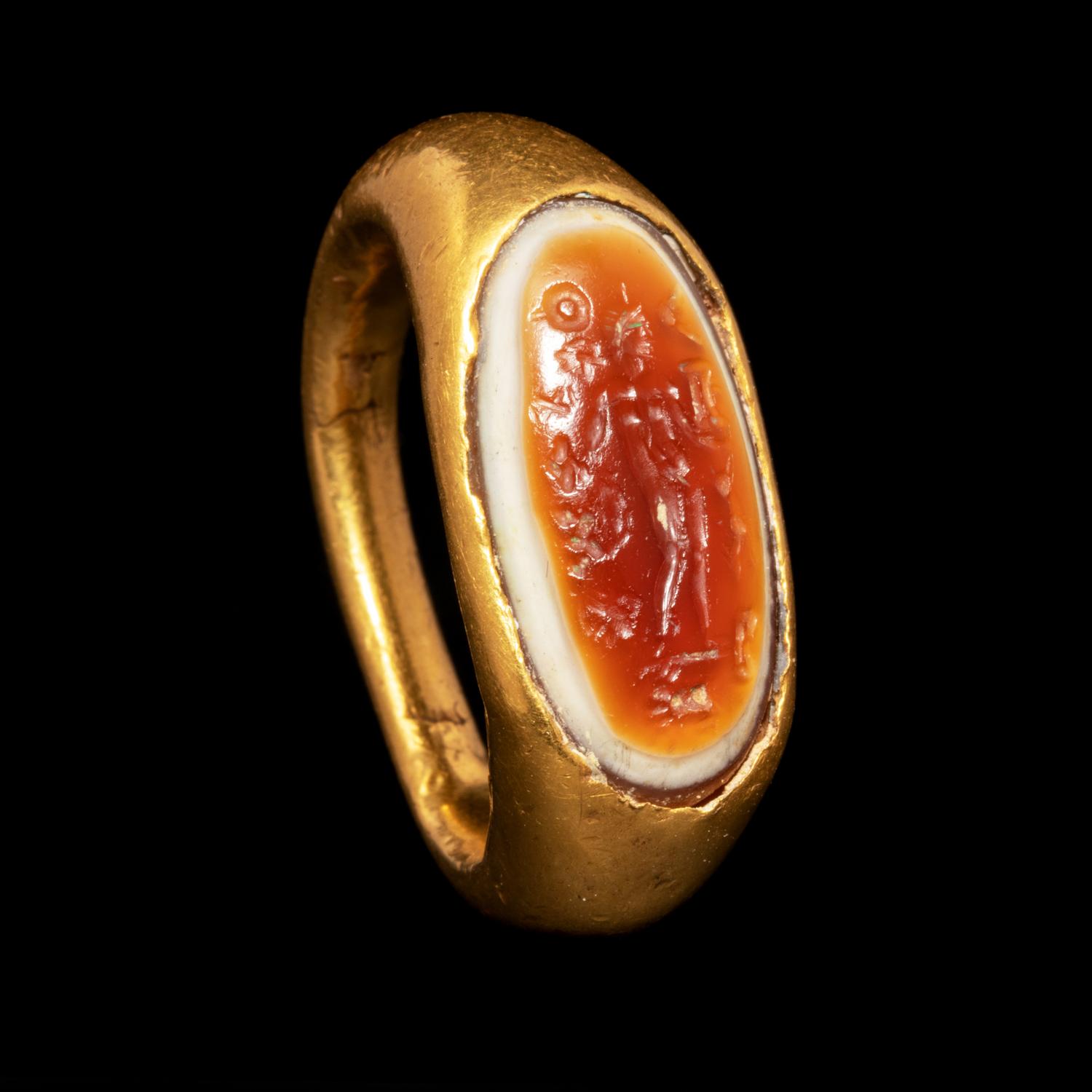 A Hellenistic Gold Finger Ring with Banded Agate Intaglio of Nude Deity