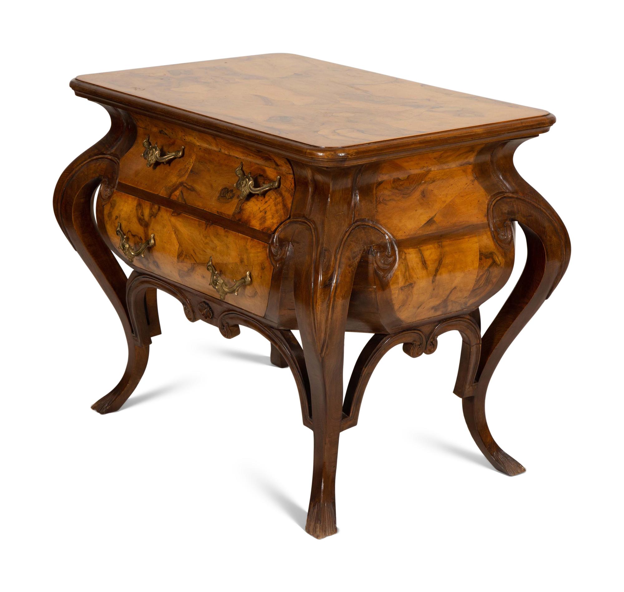 A Continental Gilt Metal Mounted Olivewood and Mahogany Bombé Commode