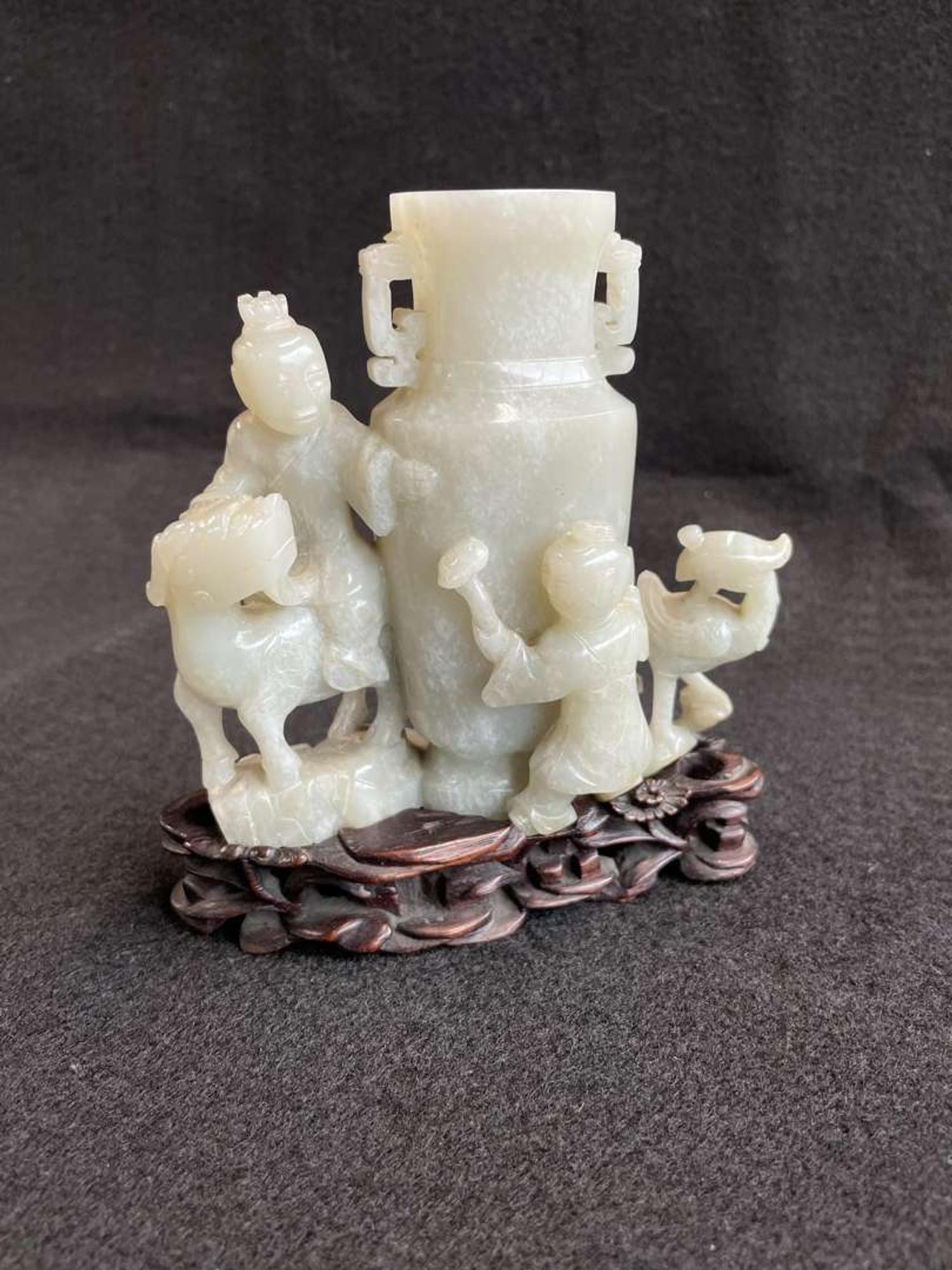 A Chinese jade "Boys, Kylin and Phoenix" vase on carved wood stand 玉雕童子凤鸟花樽及底座