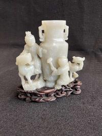 A Chinese jade "Boys, Kylin and Phoenix" vase on carved wood stand 玉雕童子凤鸟花樽及底座