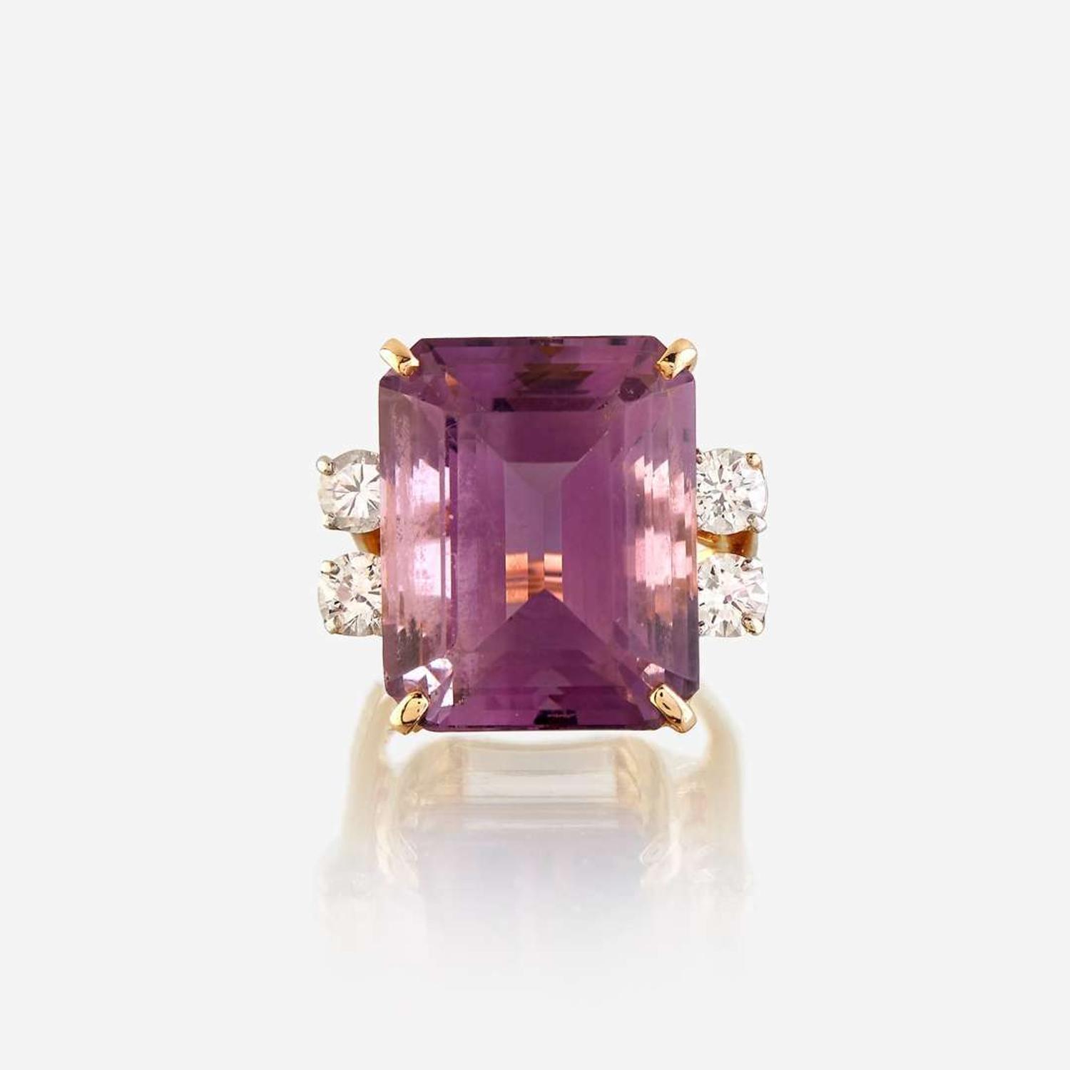 An amethyst, diamond, white stone, and gold ring