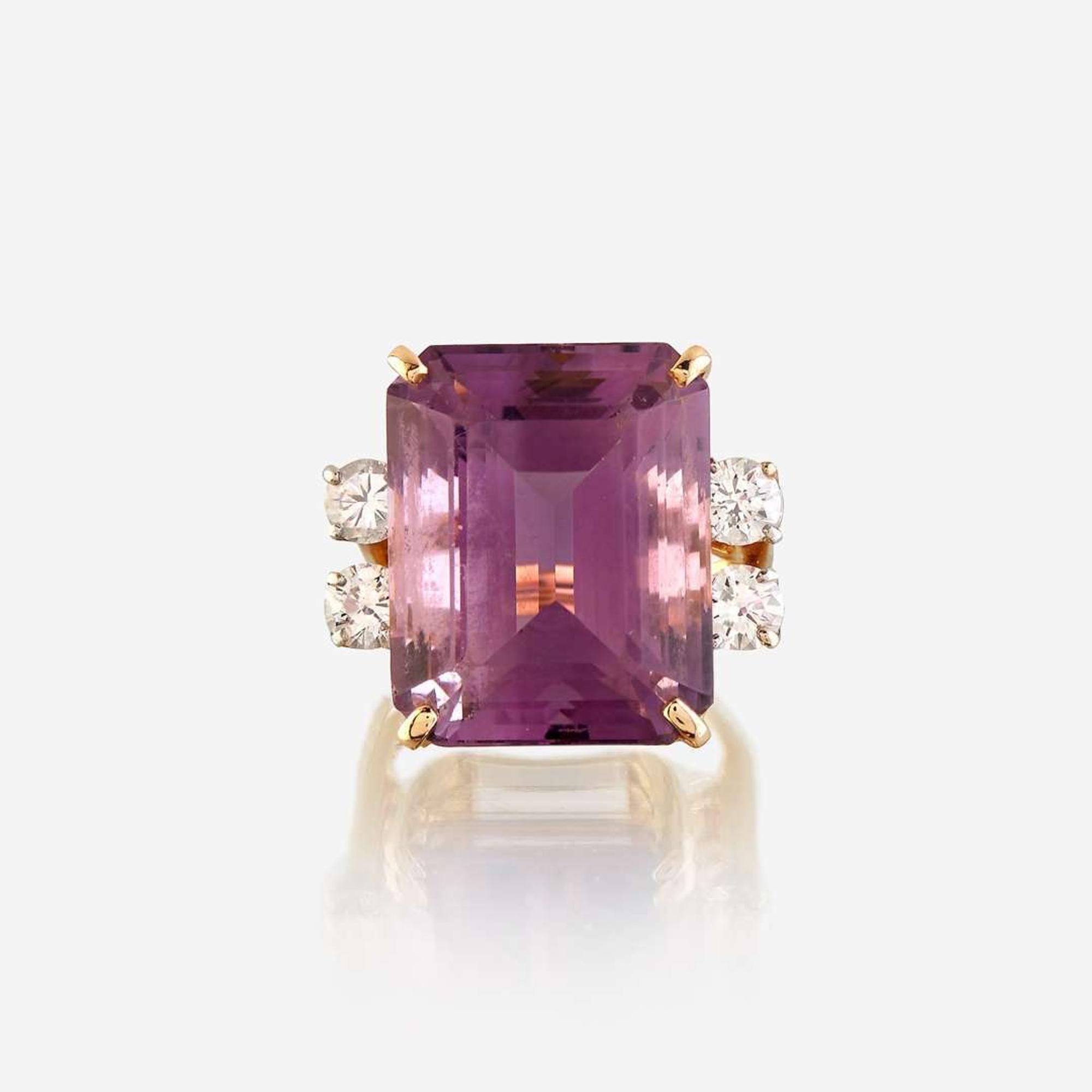 An amethyst, diamond, white stone, and gold ring