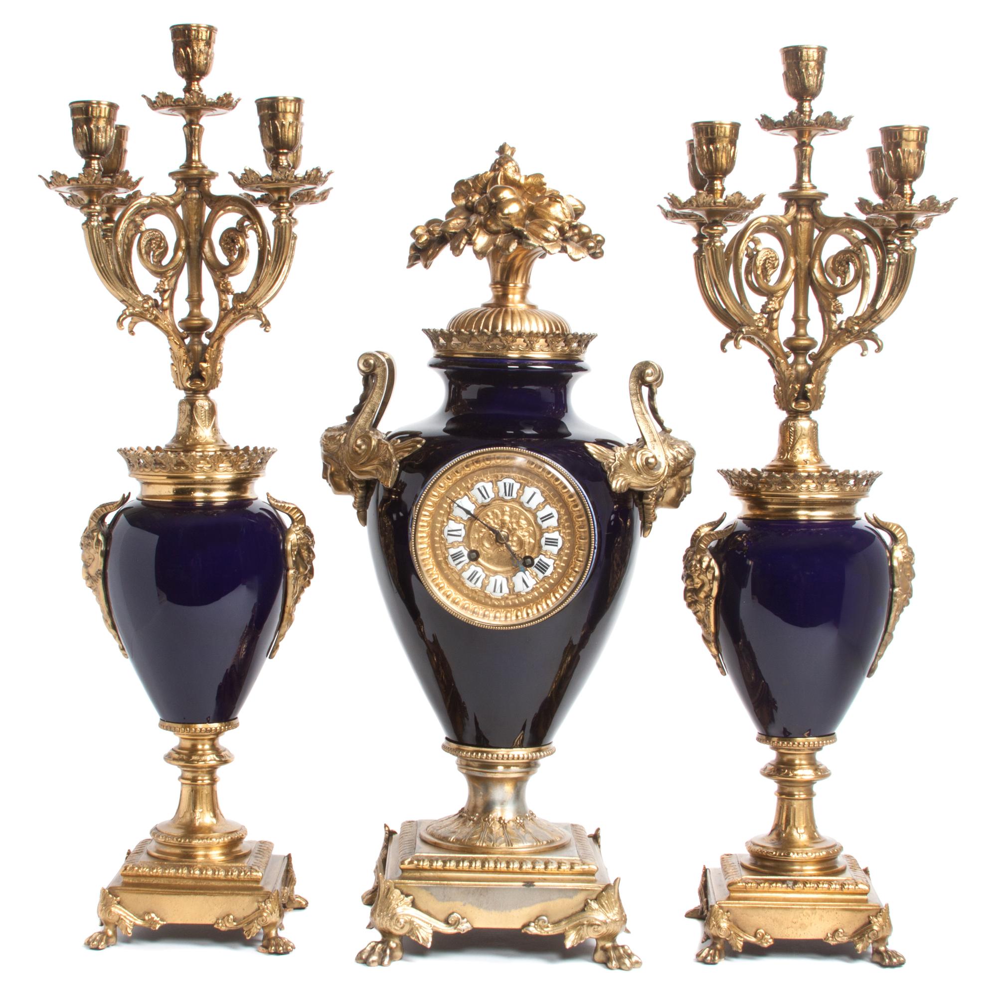 A French Blue Porcelain and Gilt Bronze Clock Garniture Height 23 x width 7 x depth 11 inches. — 19TH/20TH CENTURY