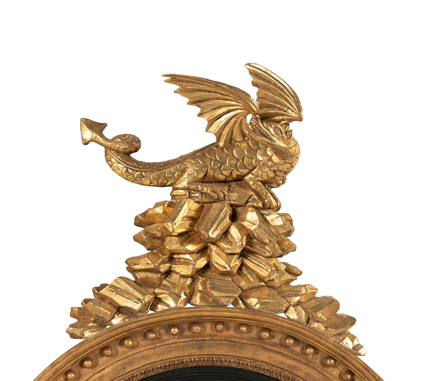 A Pair of Regency Carved Giltwood Convex Wall Mirrors