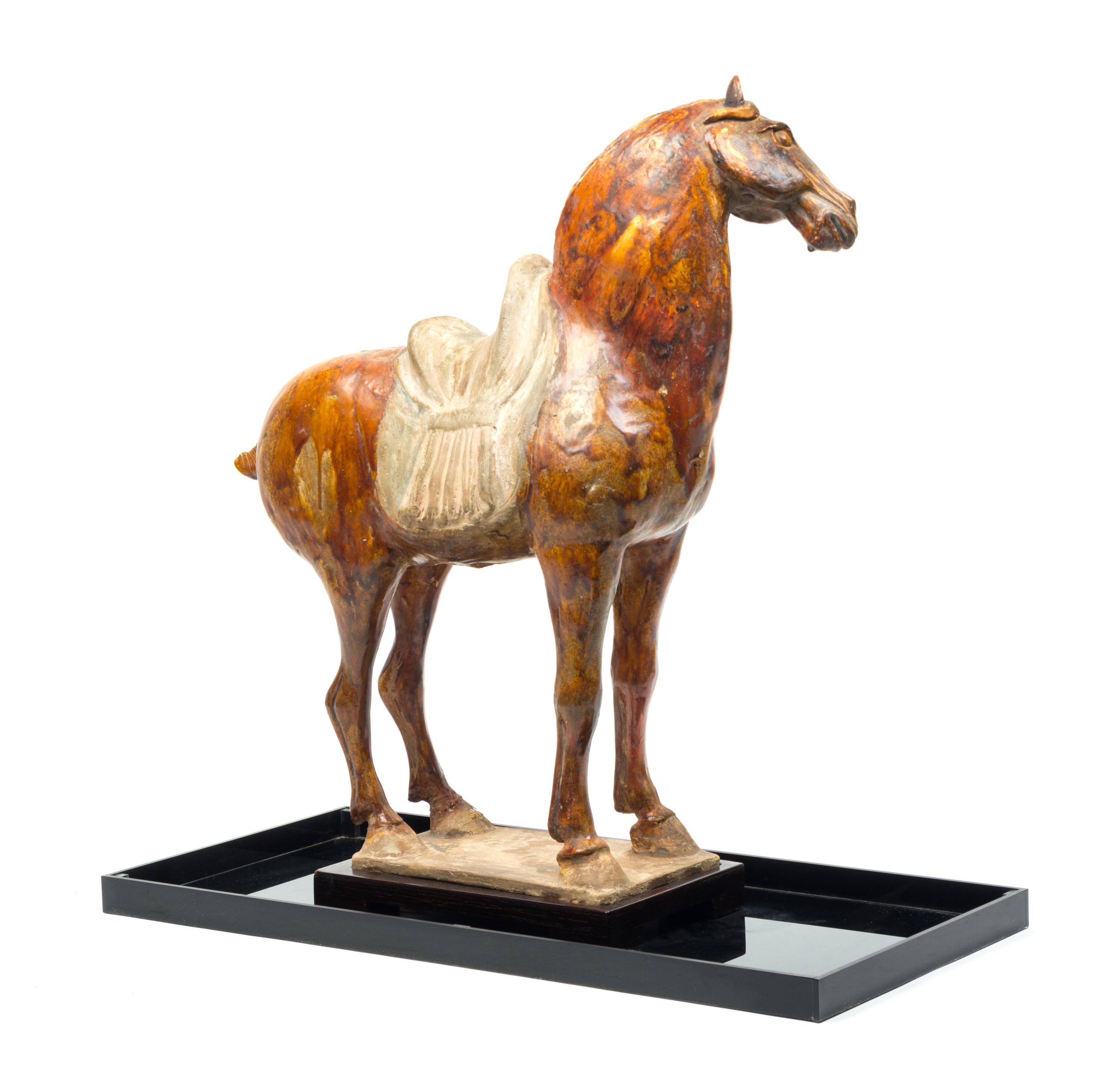 A Straw Glazed Pottery Figure of a Horse Height 21 1/4 inches. — TANG DYNASTY (618-907)