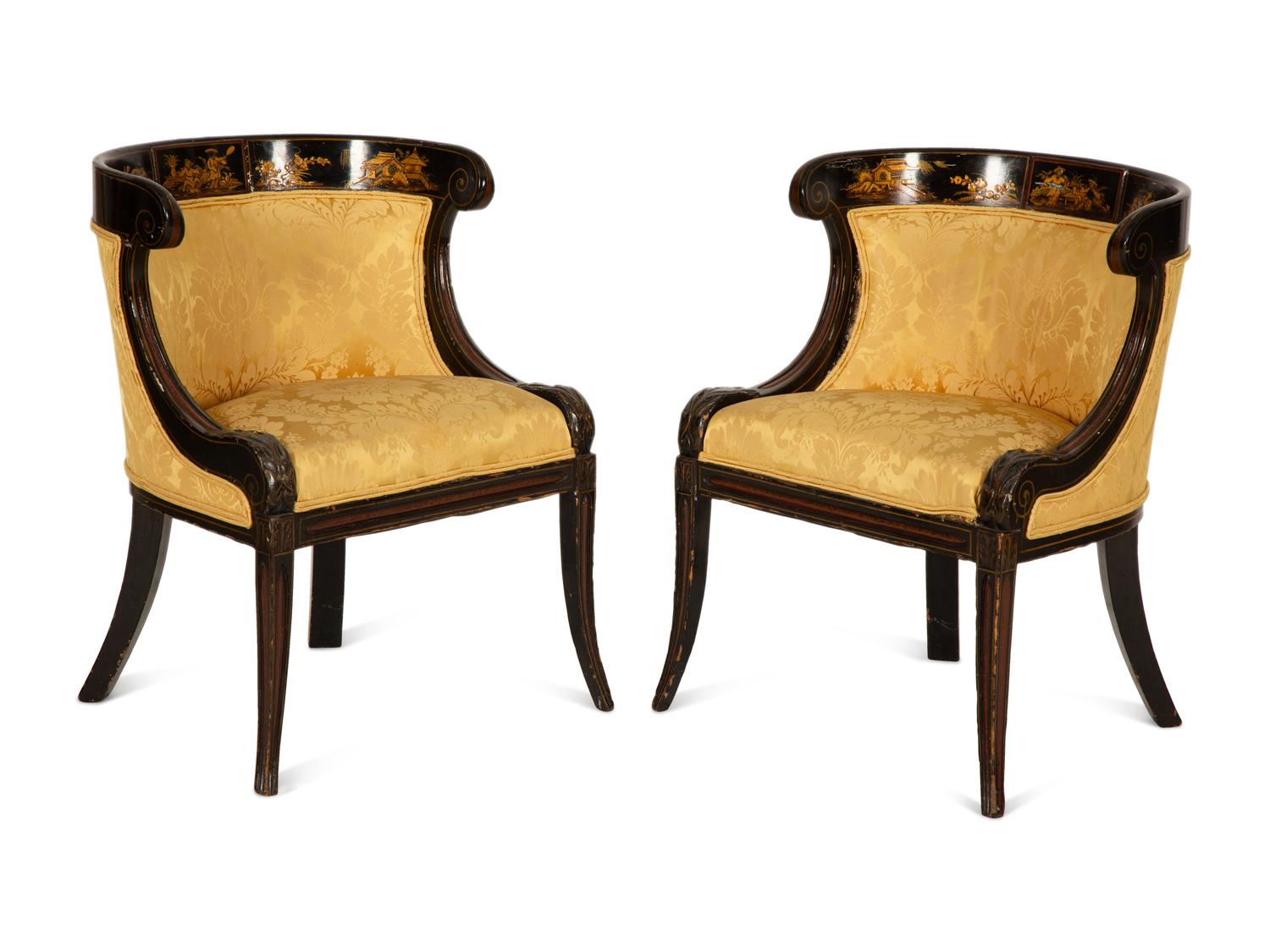 A Pair of Regency Ebonized and Gilt Barrel Back Armchairs