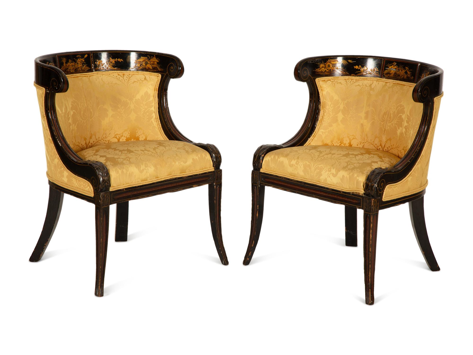 A Pair of Regency Ebonized and Gilt Barrel Back Armchairs