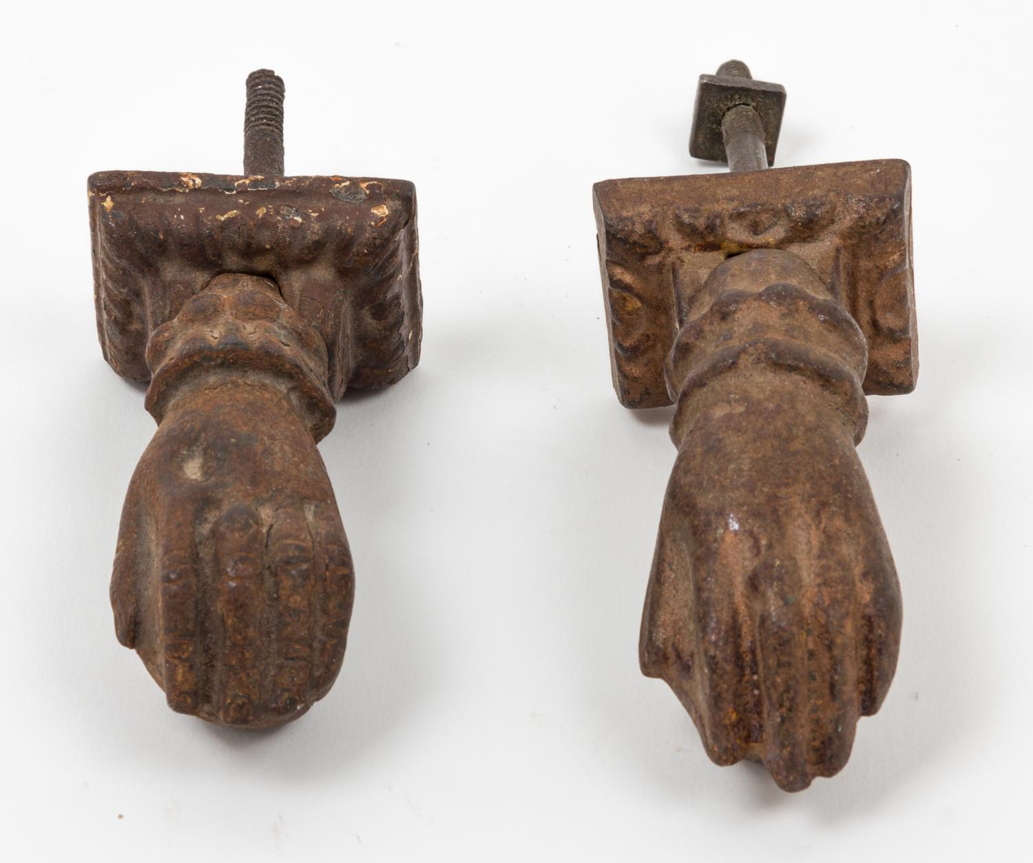 A Near Pair of Cast Metal Door Knockers Length of larger 4 inches.