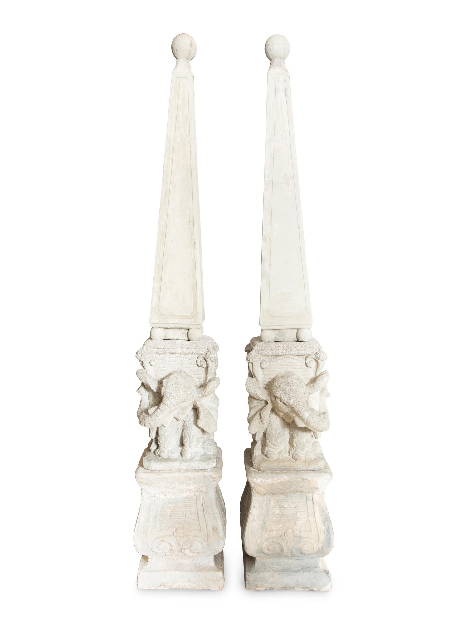 A Pair of Cast Stone Obebelisks on Elephant-Form Pedestals