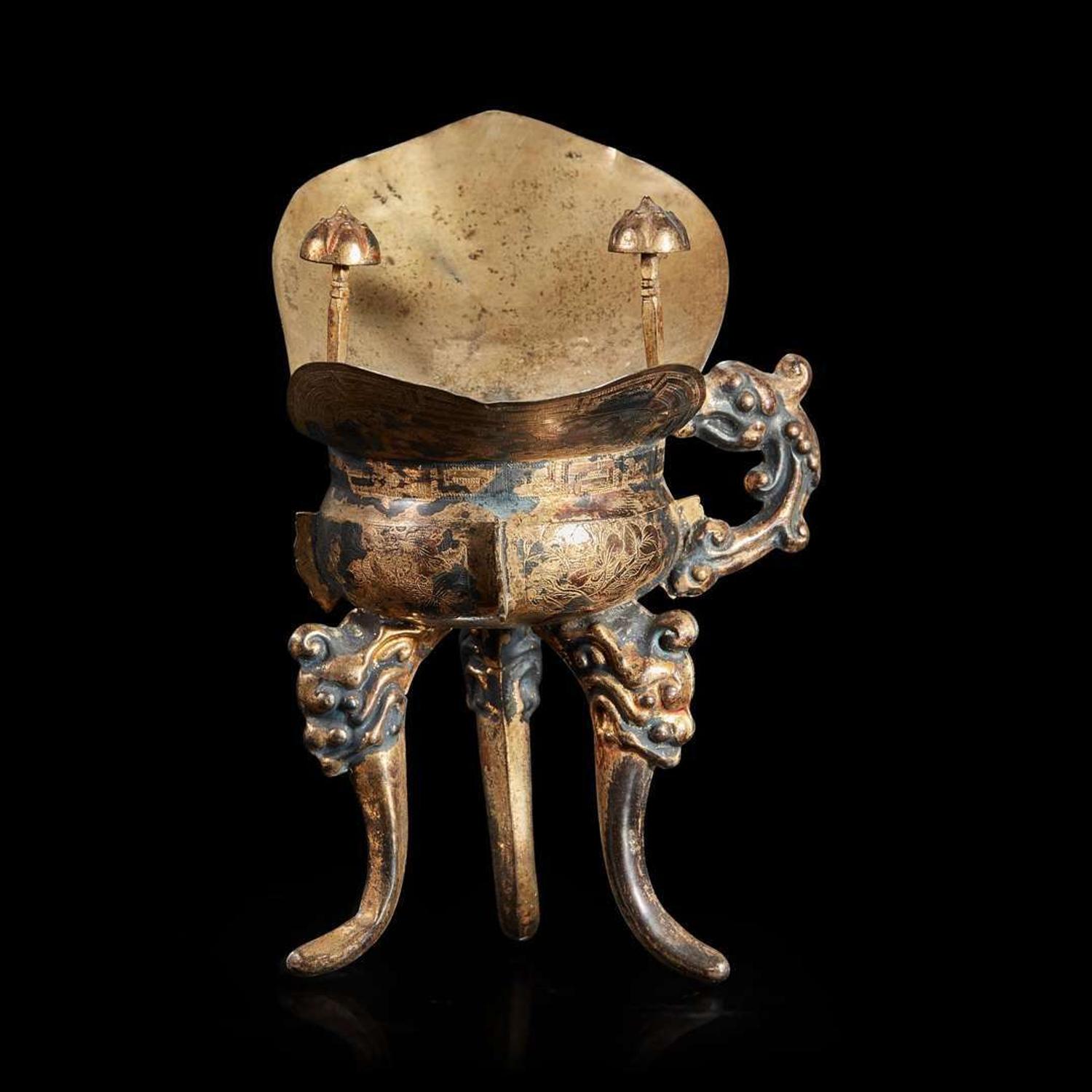 A Chinese silver-gilt tripod libation cup
