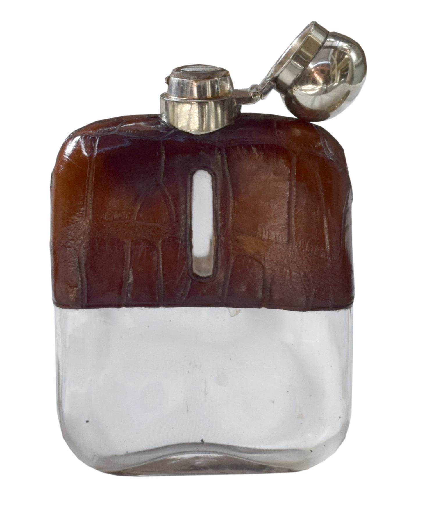A Set of Three Silver and Stamped Leather Hip Flasks Left: 2.25" x .5" x 3.75" tall: Middle: 3" x 1" x 5" tall: Right: 3.25" x 1" x 5.5 — England, Circa 1925-1940
