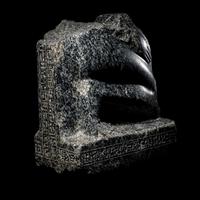 An Egyptian Gneiss Fragment of a Kneeling Figure