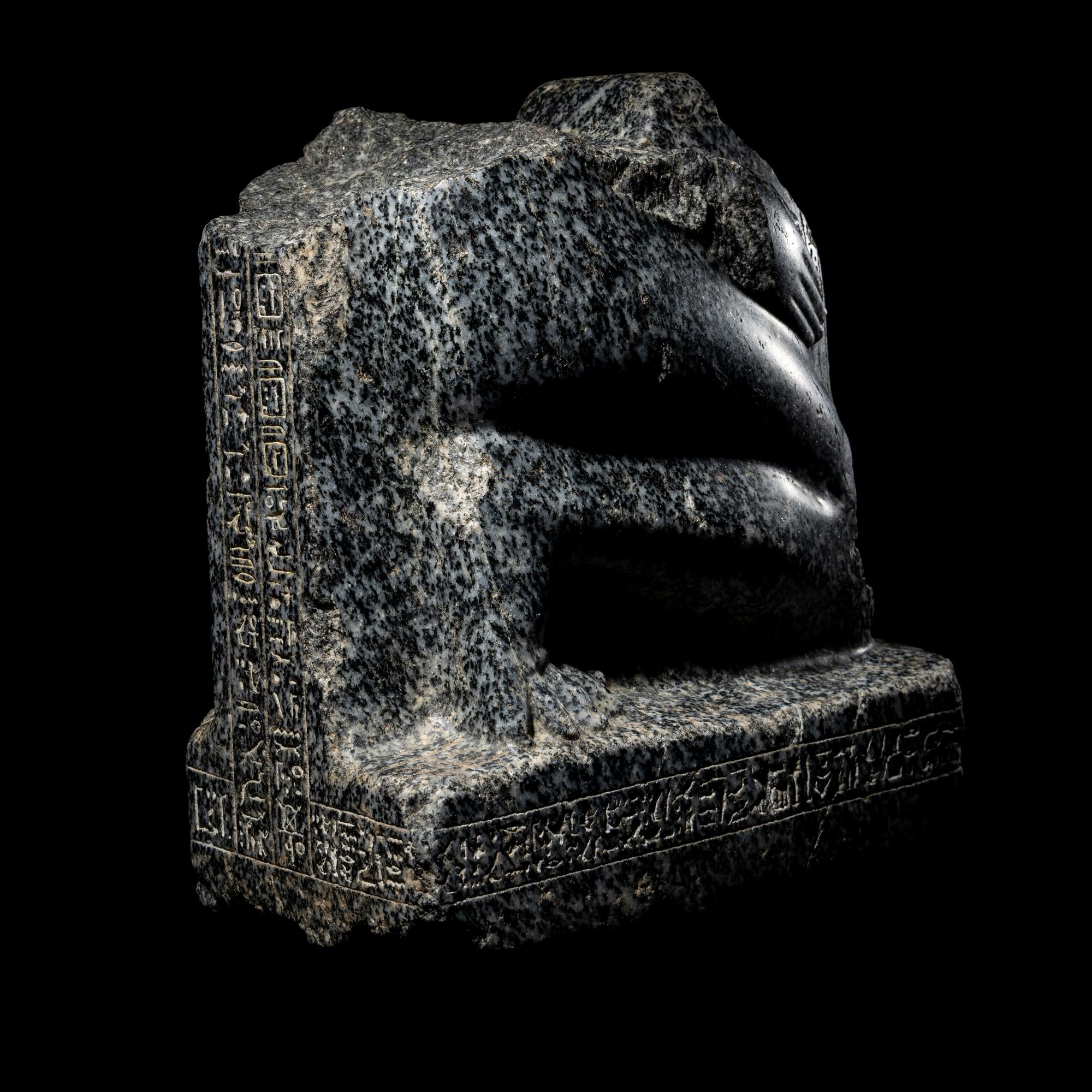 An Egyptian Gneiss Fragment of a Kneeling Figure