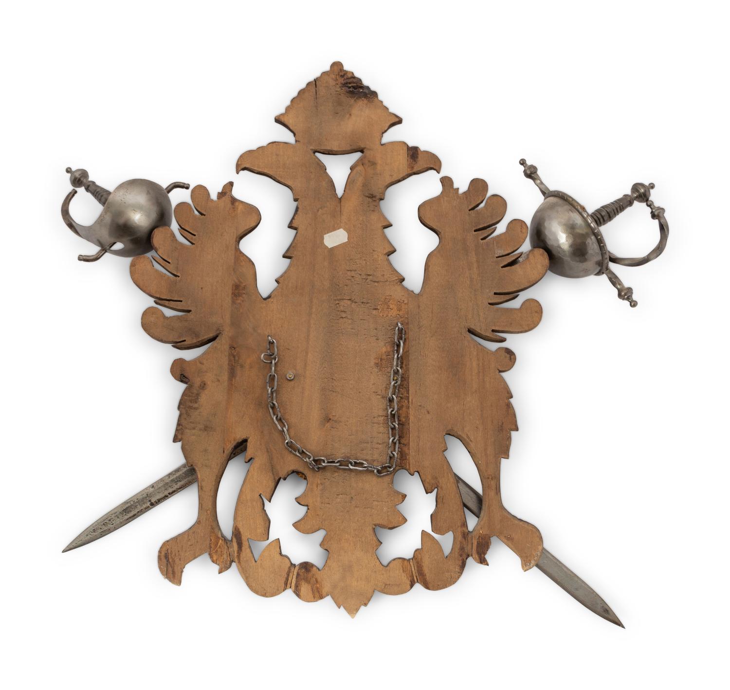 A Continental Carved Armor Trophy with Crossed Swords
