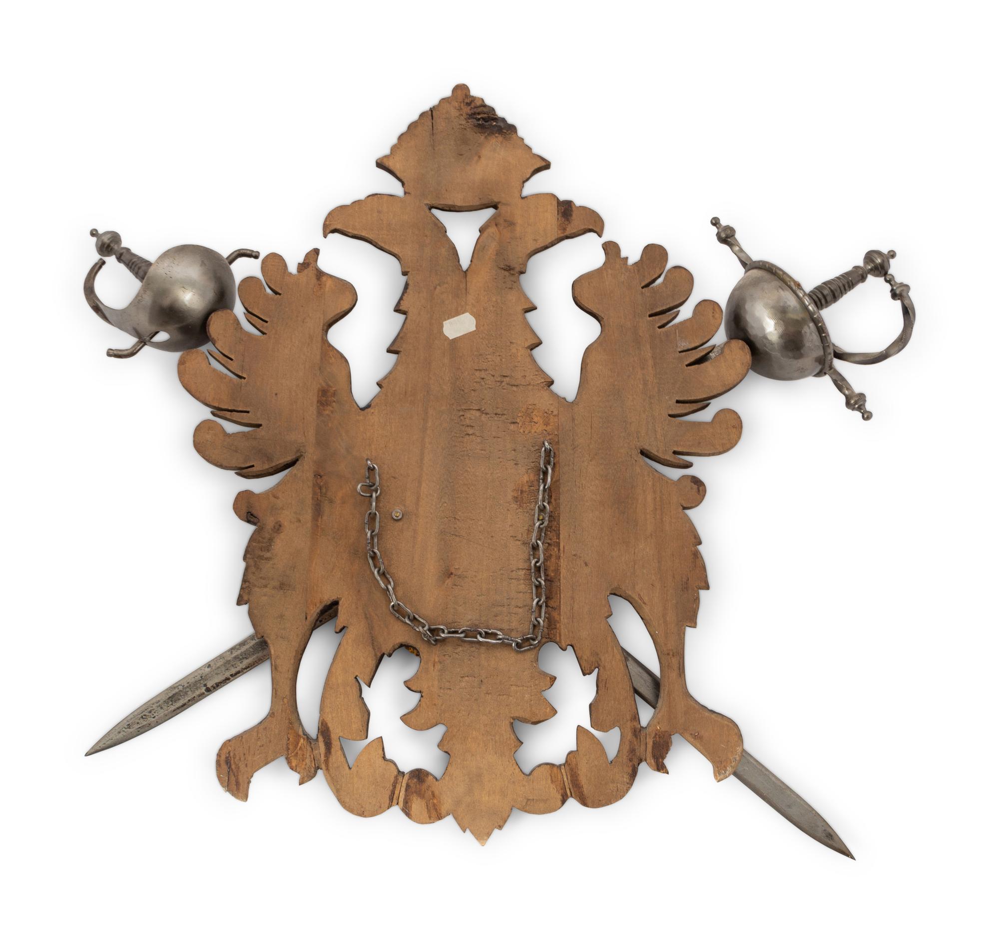 A Continental Carved Armor Trophy with Crossed Swords