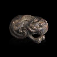 A Chinese Patinated Bronze Figure of a Stylized Lion, Late Ming-Early Qing Dynasty — 明末清初 銅獅鎮紙