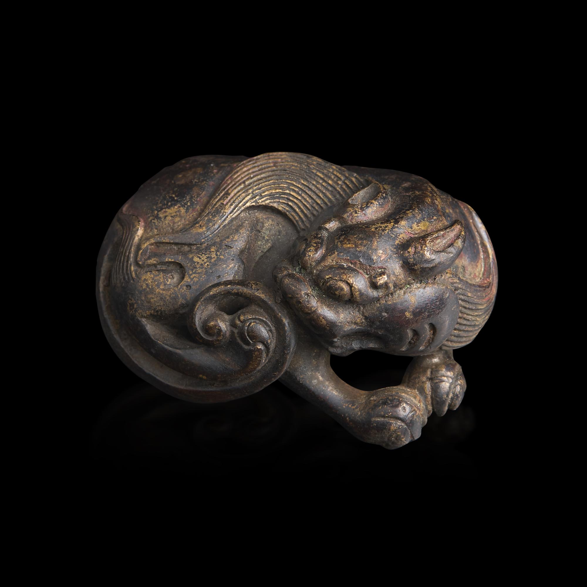 A Chinese Patinated Bronze Figure of a Stylized Lion, Late Ming-Early Qing Dynasty — 明末清初 銅獅鎮紙