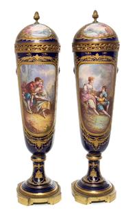 A Pair of Sevres Porcelain Lidded Urns Height 28 inches.
