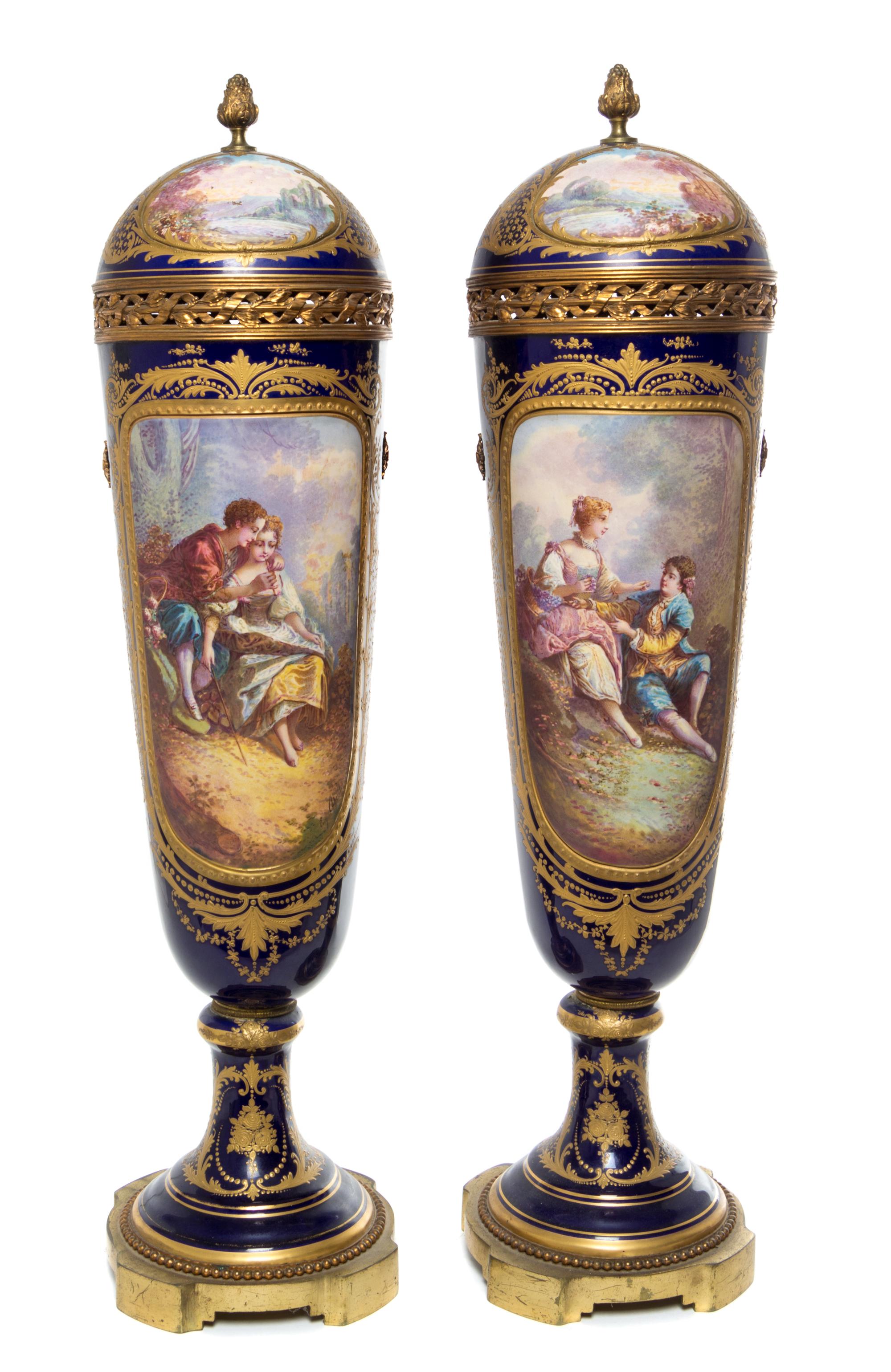 A Pair of Sevres Porcelain Lidded Urns Height 28 inches.