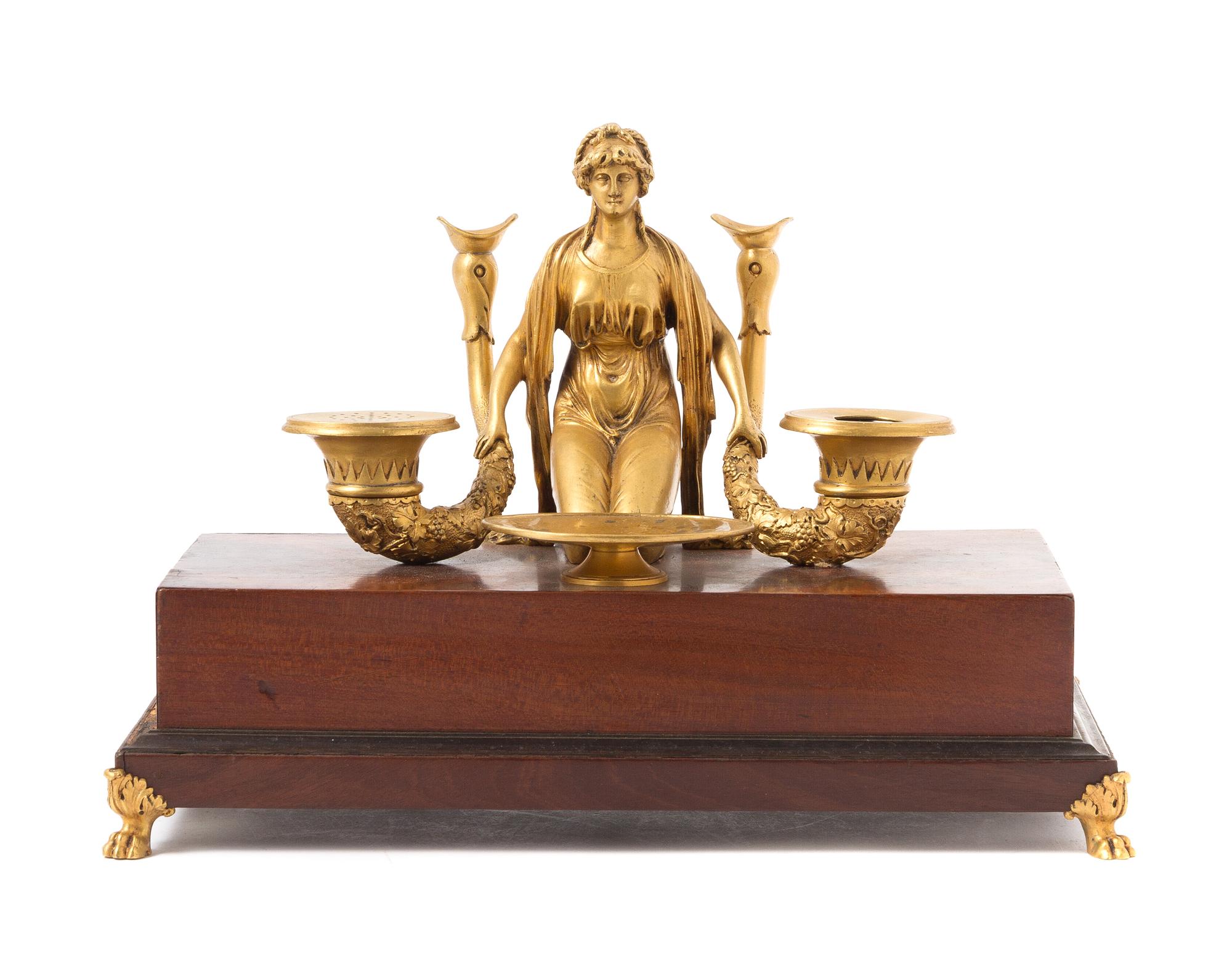 An Empire Style Gilt Bronze Mounted Mahogany Figural Encrier Length overall 12 inches.
