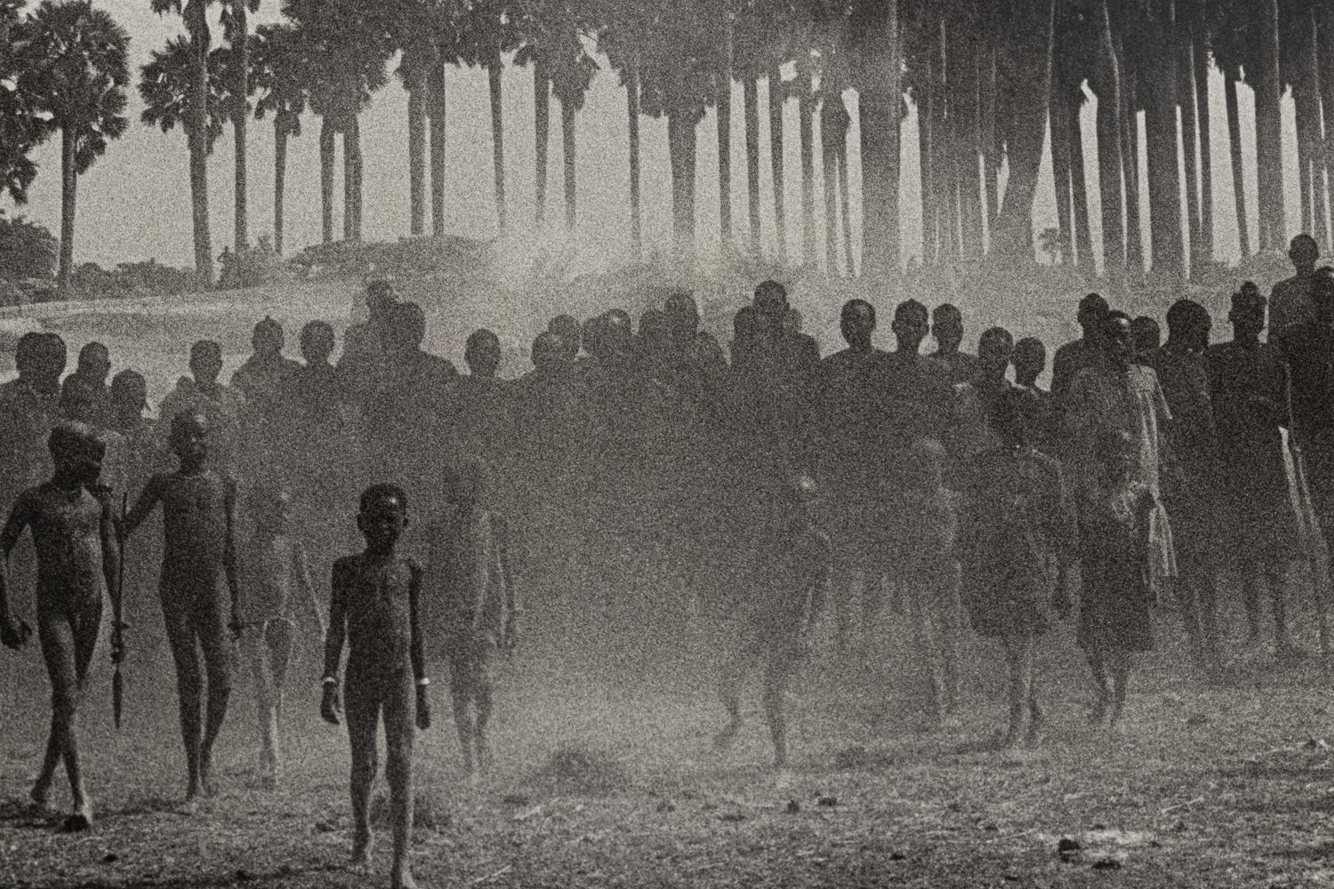 Sebastião Salgado (born 1944) The population of the cattle camp of Kenya walk toward the polio vaccinators as soon as they arrive, Maper Payem area, Rumbek District, Southern Sudan, 2001