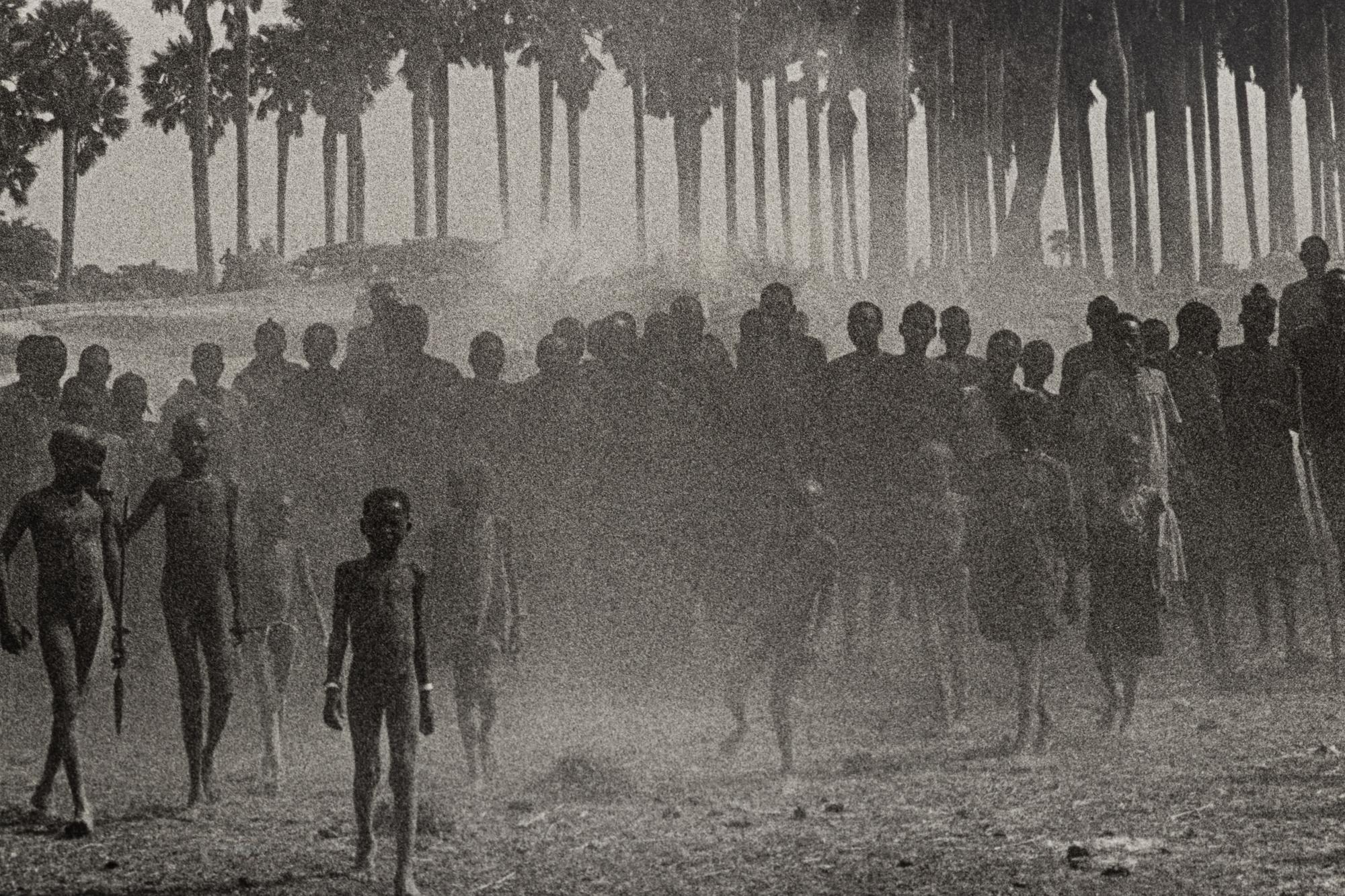 Sebastião Salgado (born 1944) The population of the cattle camp of Kenya walk toward the polio vaccinators as soon as they arrive, Maper Payem area, Rumbek District, Southern Sudan, 2001