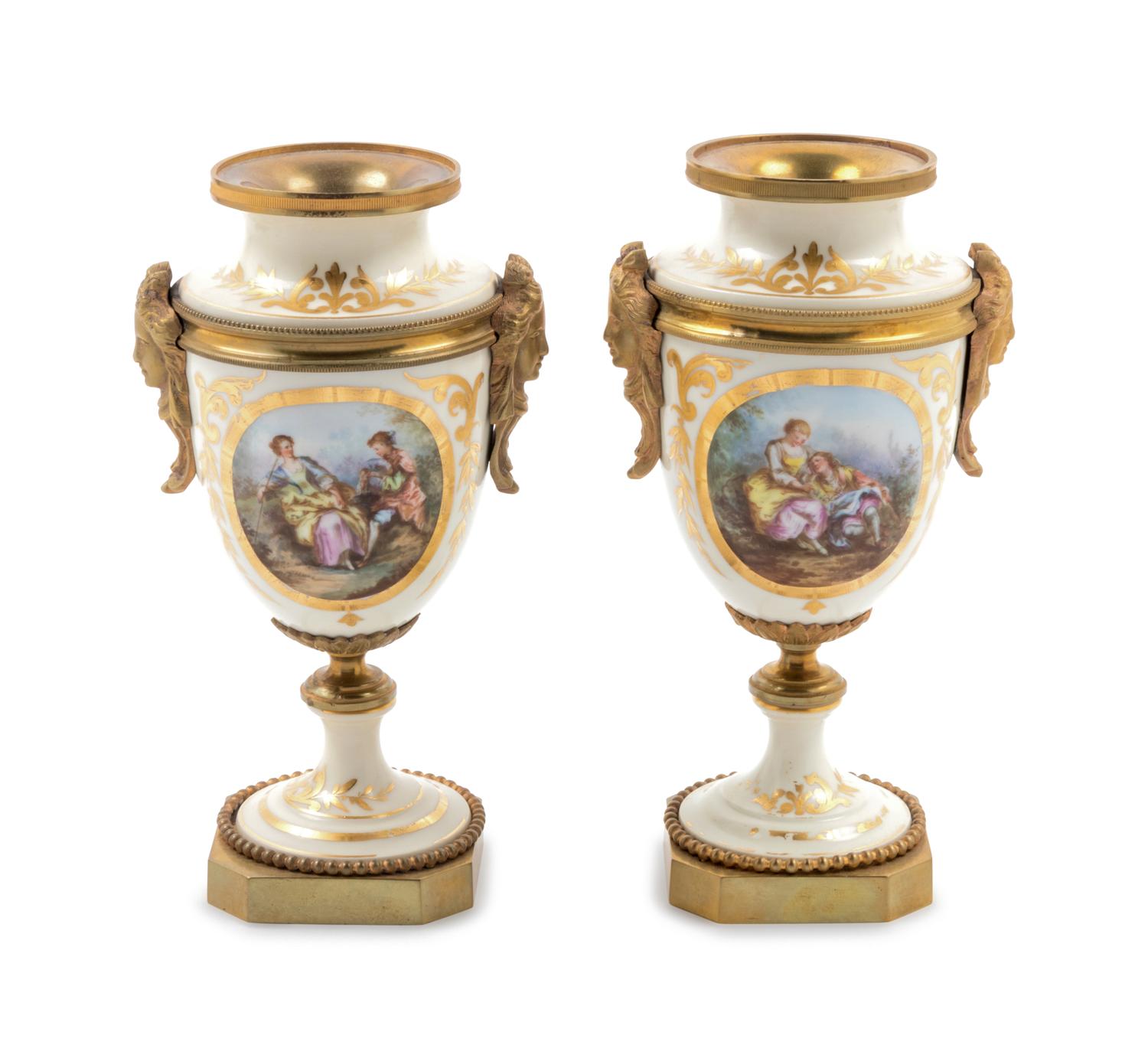 A Pair of Sèvres Style Gilt Bronze Mounted Painted and Parcel Gilt Porcelain Urns