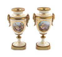 A Pair of Sèvres Style Gilt Bronze Mounted Painted and Parcel Gilt Porcelain Urns