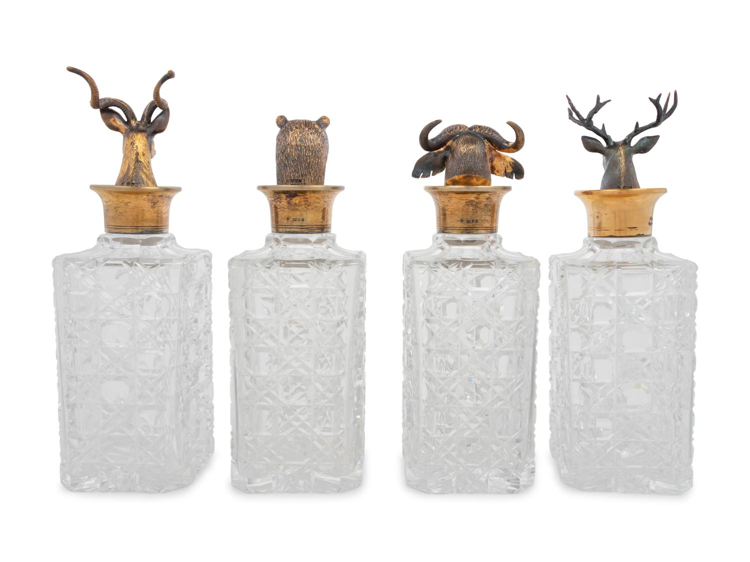 A Set of Four English Silver Mounted Cut-Glass Decanters