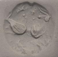A Minoan Black Steatite Lentoid with a Bull Head and Leaf.