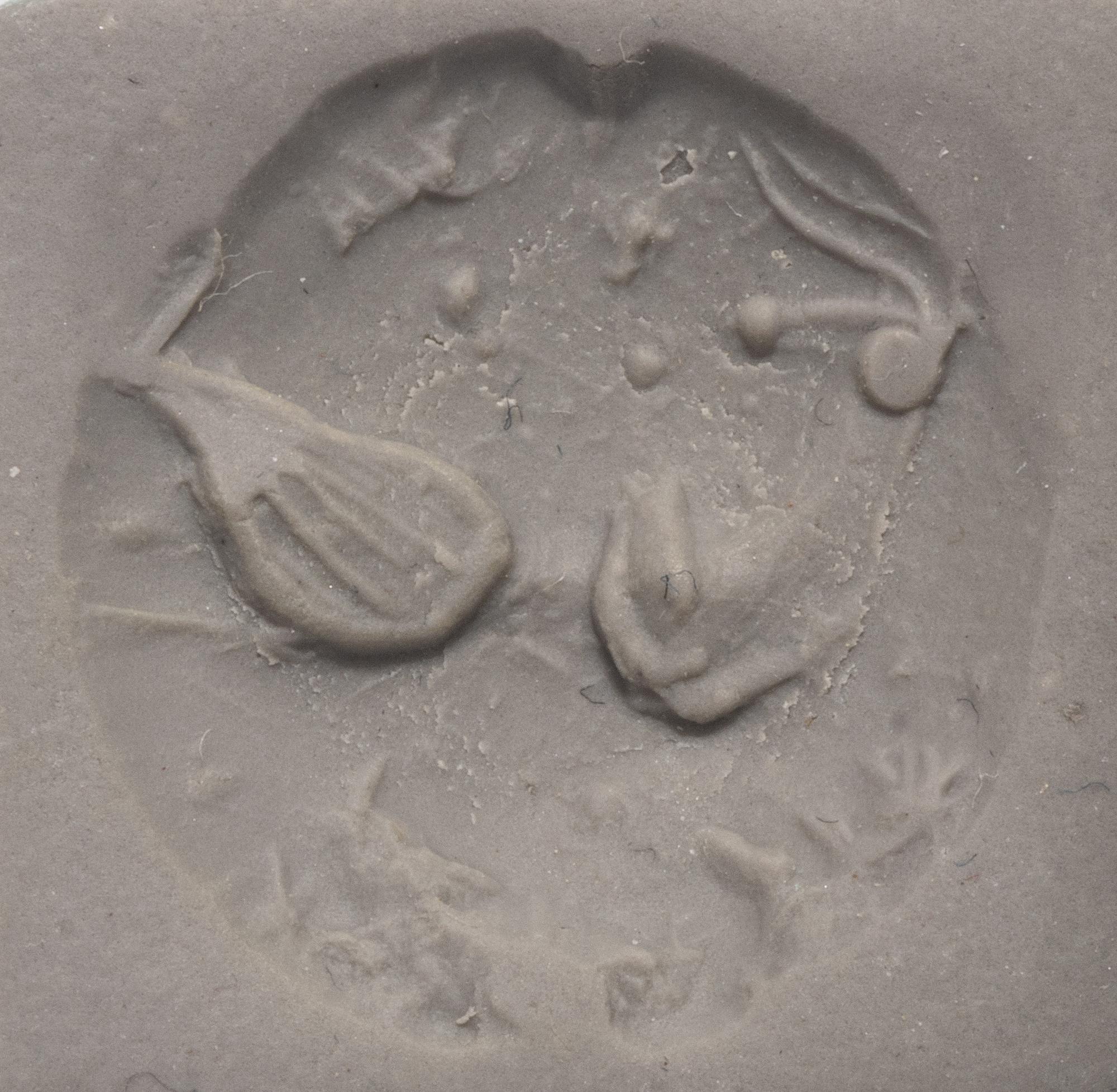 A Minoan Black Steatite Lentoid with a Bull Head and Leaf.
