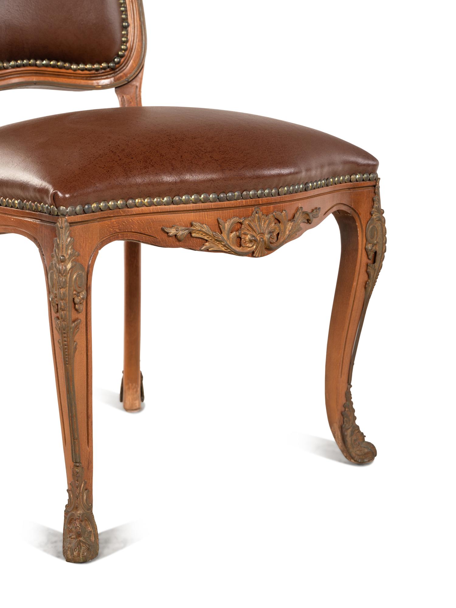 A Set of Four Louis XV Style Gilt Bronze Mounted Dining Chairs