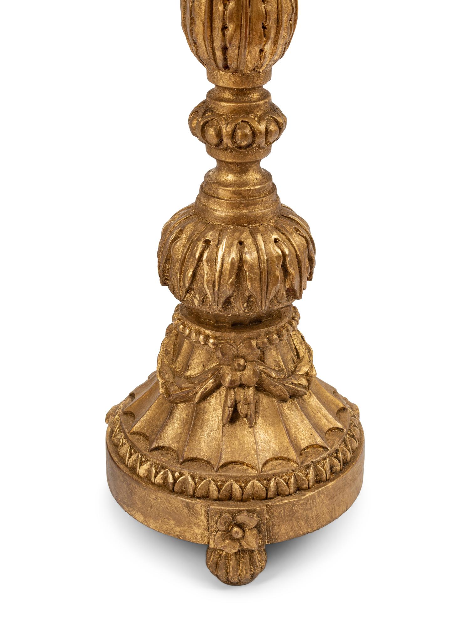 A Pair of Italian Neoclassical Carved and Parcel Gilt Candlesticks